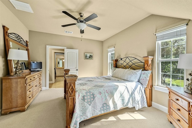 carpeted bedroom featuring multiple windows, ceiling fan, and vaulted ceiling