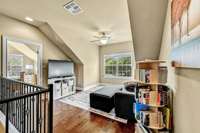 living room featuring a textured ceiling, hardwood / wood-style flooring, ceiling fan, and a healthy amount of sunlight