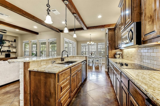 kitchen featuring beamed ceiling, stainless steel appliances, hanging light fixtures, and sink