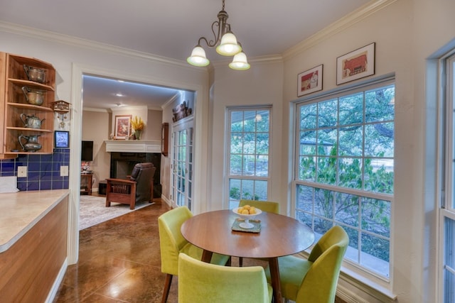 tiled dining area featuring crown molding and an inviting chandelier