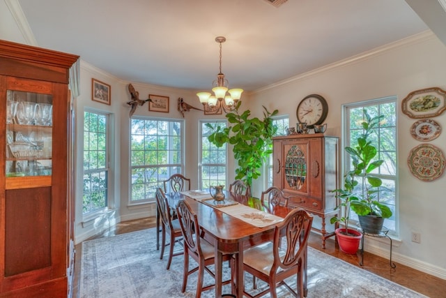 dining area featuring a wealth of natural light, crown molding, and a notable chandelier