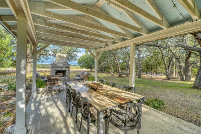 view of patio with an outdoor stone fireplace