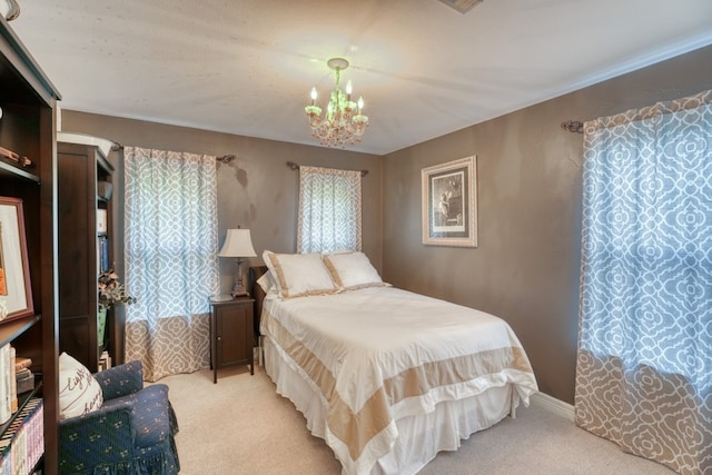 carpeted bedroom featuring a chandelier