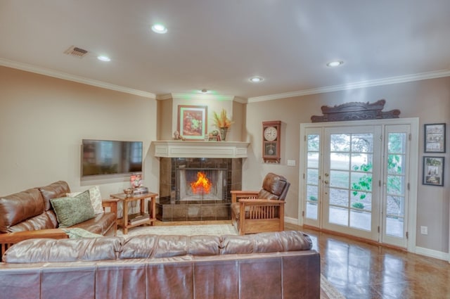 living room with a tiled fireplace and ornamental molding