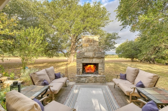 view of patio featuring an outdoor living space with a fireplace