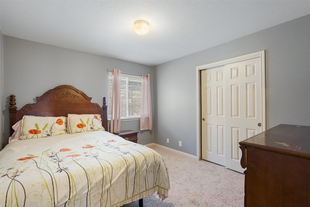 bedroom with light carpet and a closet