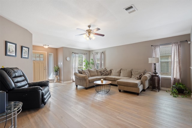 living room with light hardwood / wood-style floors and ceiling fan