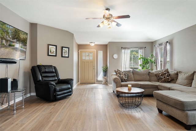 living room featuring ceiling fan and light hardwood / wood-style flooring