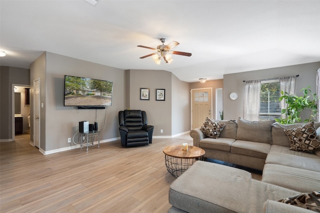 living room with light wood-type flooring and ceiling fan