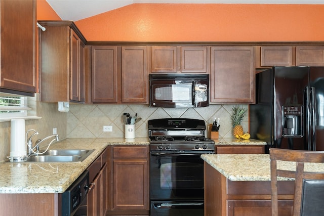 kitchen featuring tasteful backsplash, black appliances, sink, vaulted ceiling, and light stone counters