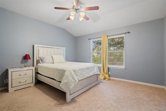 bedroom with vaulted ceiling, light colored carpet, and ceiling fan