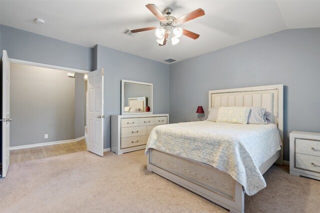 carpeted bedroom featuring lofted ceiling and ceiling fan