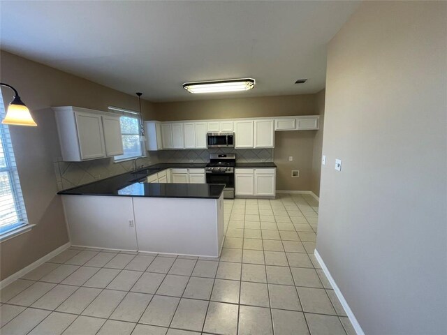 kitchen featuring pendant lighting, stainless steel appliances, and white cabinets