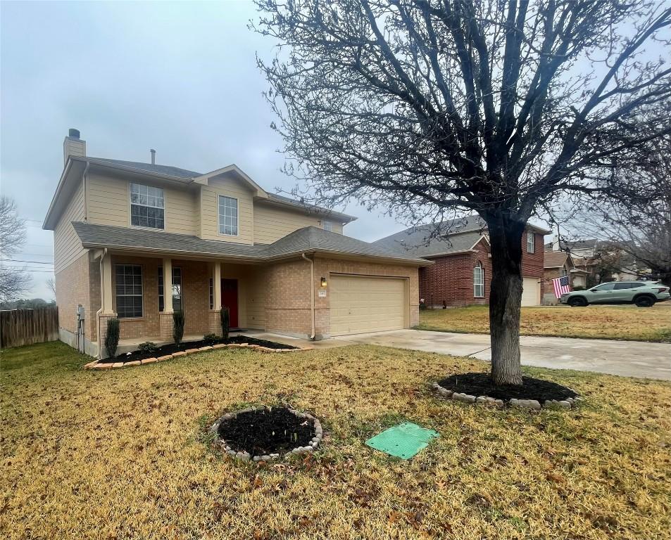 view of front of home with a garage and a front yard