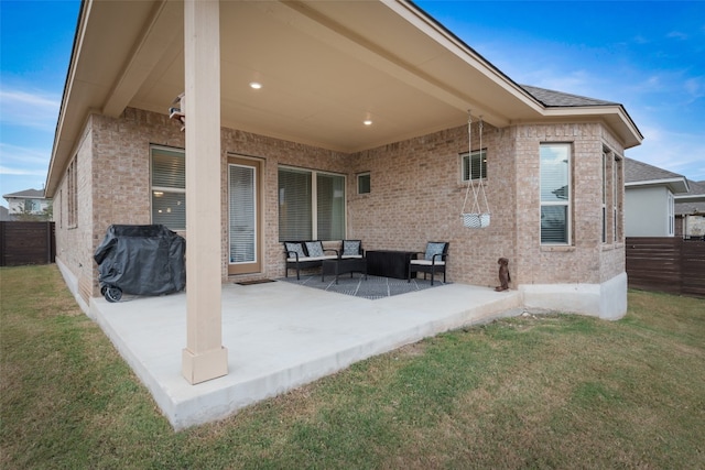 back of property featuring a yard, a patio, and an outdoor hangout area