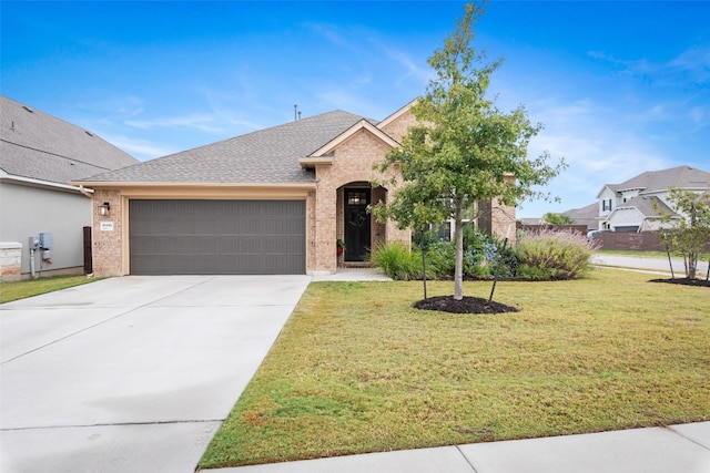 view of front of home featuring a front lawn and a garage