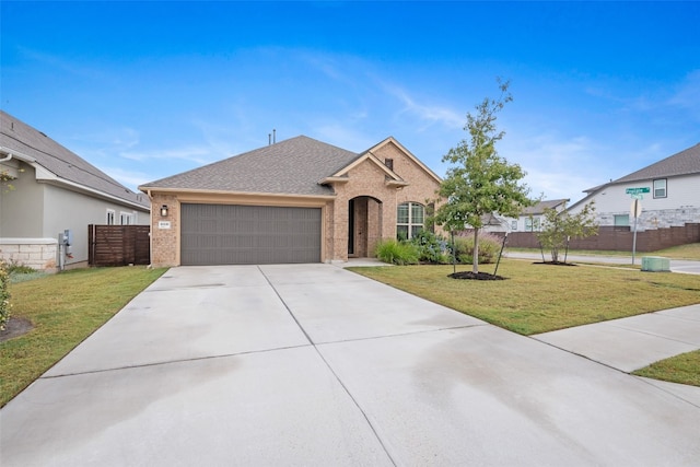 view of front of home featuring a front lawn and a garage