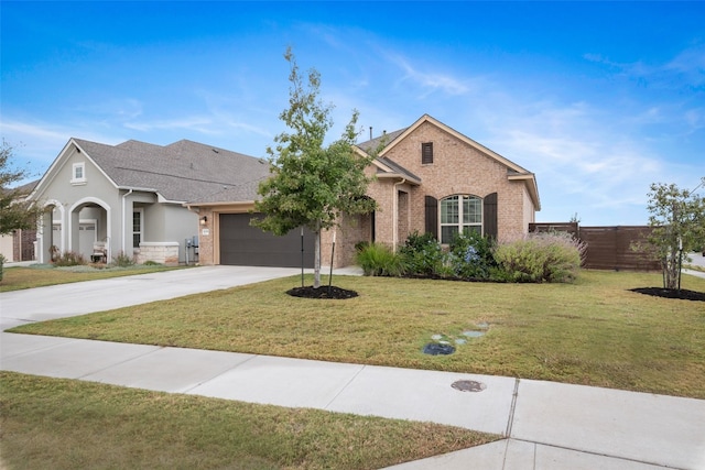 view of front of house with a front yard and a garage