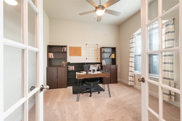 carpeted office space with french doors and ceiling fan