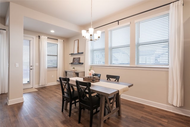 dining room with a notable chandelier and dark hardwood / wood-style floors