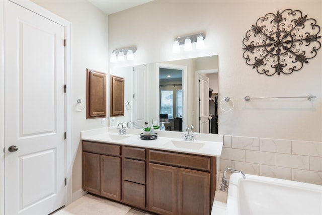 bathroom featuring vanity, tile patterned flooring, and a bathing tub