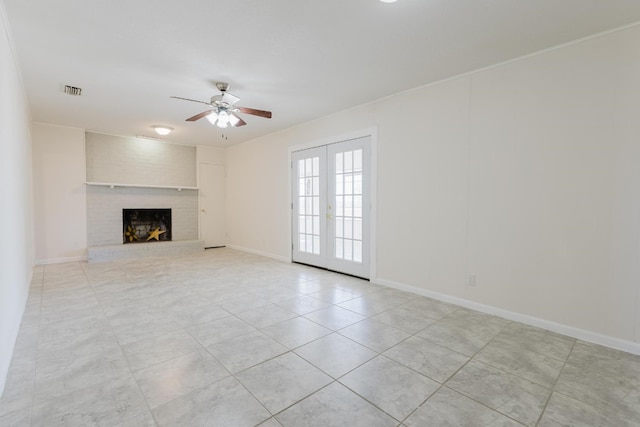 unfurnished living room featuring french doors, a fireplace, and ceiling fan