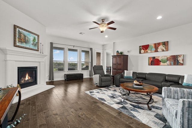 living room with ceiling fan and dark hardwood / wood-style flooring