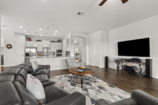 3224 Desert Shade Bnd, Leander, TX 78641 - living room with a ceiling fan, arched walkways, dark wood-style flooring, and recessed lighting