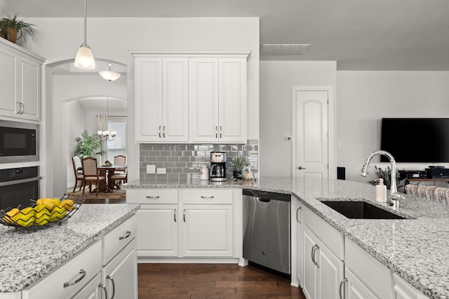 kitchen with oven, visible vents, a sink, built in microwave, and dishwasher