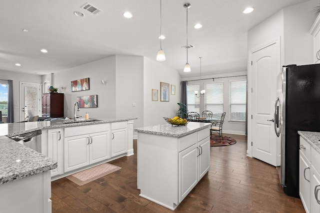3224 Desert Shade Bnd, Leander, TX 78641 - kitchen featuring appliances with stainless steel finishes, a center island, dark wood finished floors, recessed lighting, and white cabinetry
