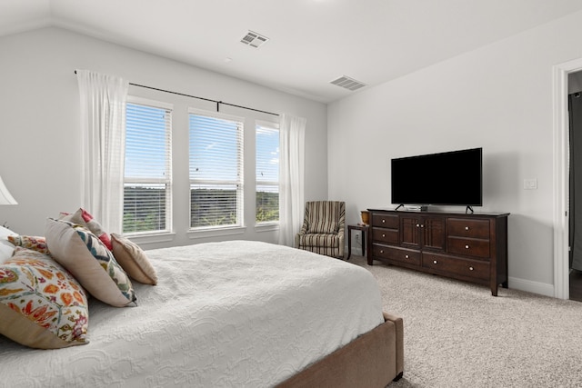 bedroom featuring vaulted ceiling and light carpet