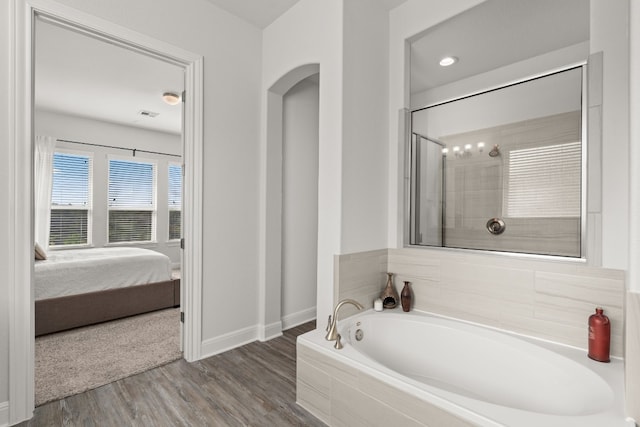 3224 Desert Shade Bnd, Leander, TX 78641 - ensuite bathroom with a garden tub and wood finished floors