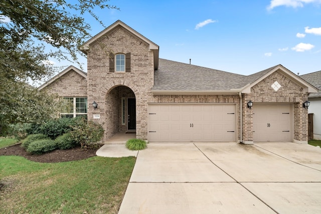 3224 Desert Shade Bnd, Leander, TX 78641 - view of front facade with brick siding, a garage, driveway, and a shingled roof
