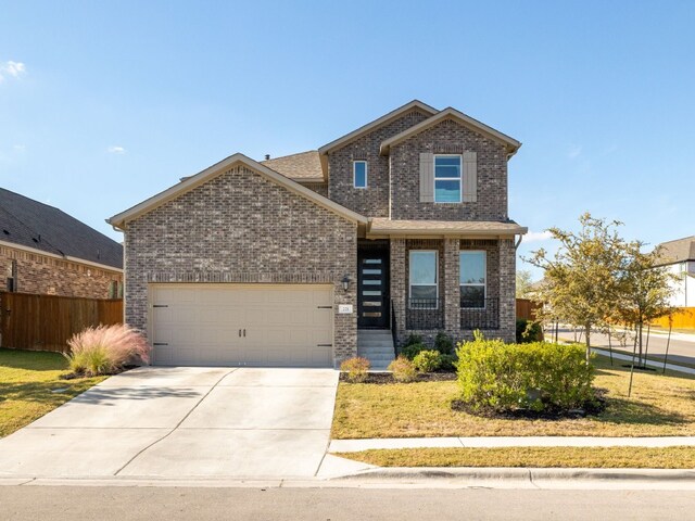 front of property featuring a garage and a front lawn