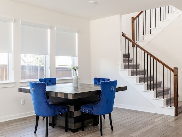 dining space featuring wood-type flooring