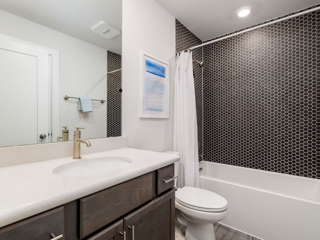 full bathroom featuring hardwood / wood-style flooring, vanity, shower / bath combo, and toilet