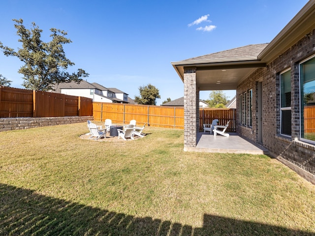 view of yard featuring a fire pit and a patio