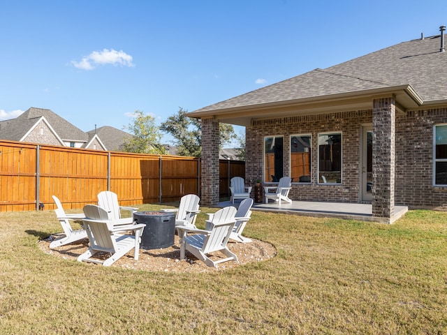 view of yard featuring a patio and an outdoor fire pit