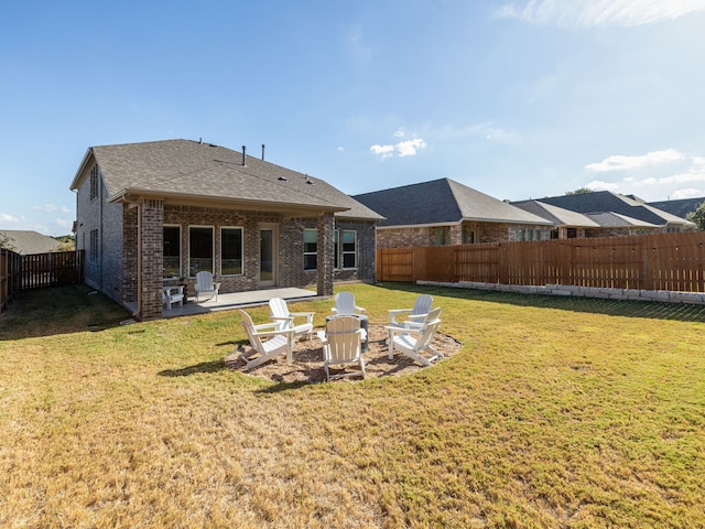 back of house with a lawn and a patio