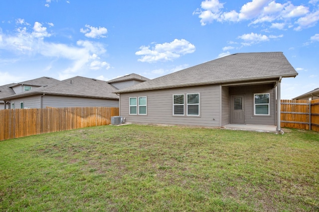 rear view of property with a patio area, central AC, and a lawn