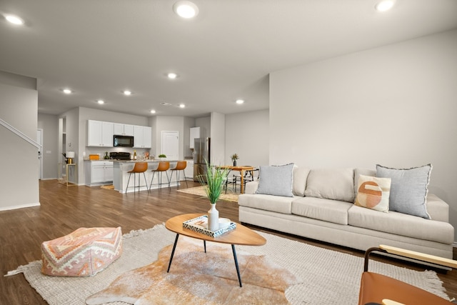 living room with dark hardwood / wood-style flooring