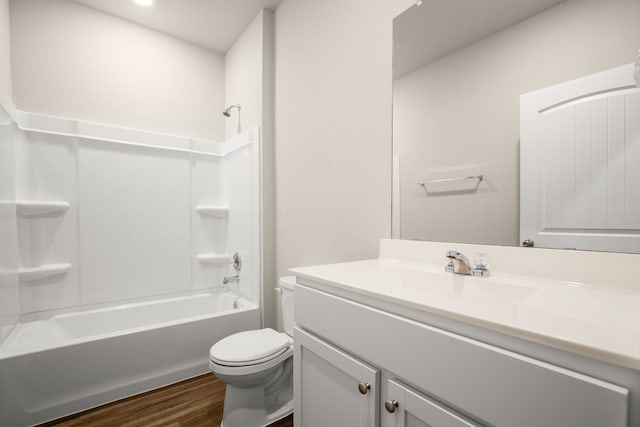 full bathroom with toilet, vanity, wood-type flooring, and shower / bathtub combination