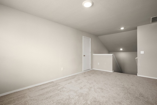 additional living space with lofted ceiling and carpet floors