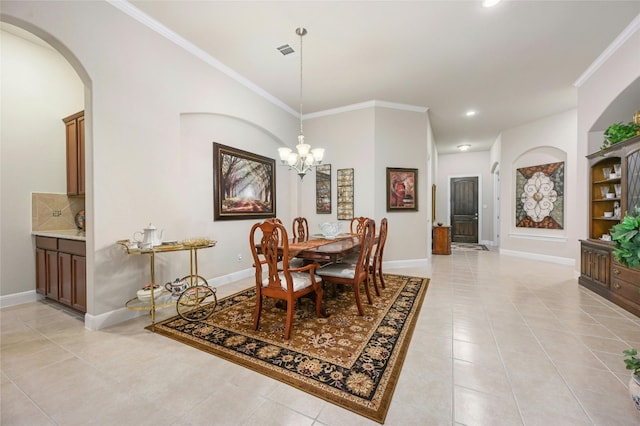 tiled dining room featuring an inviting chandelier and ornamental molding