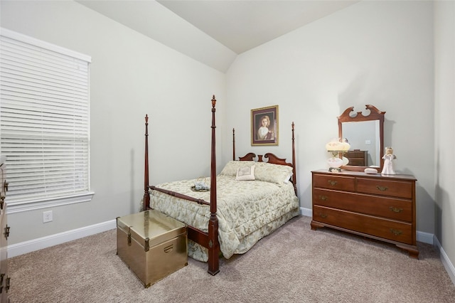 bedroom with light carpet and lofted ceiling