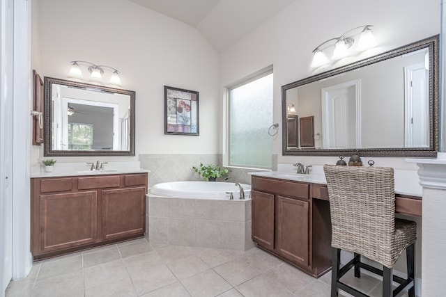 bathroom featuring tile patterned flooring, vanity, a relaxing tiled tub, and lofted ceiling