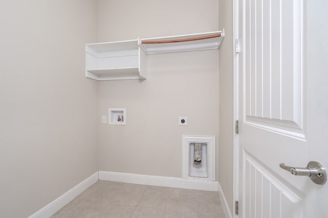 clothes washing area featuring hookup for a washing machine, electric dryer hookup, and light tile patterned flooring