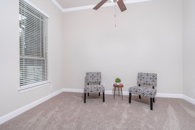 sitting room featuring carpet floors, ceiling fan, and crown molding