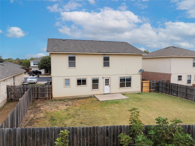 back of house featuring a patio area and a lawn