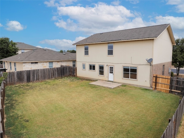 rear view of house featuring a patio area and a lawn